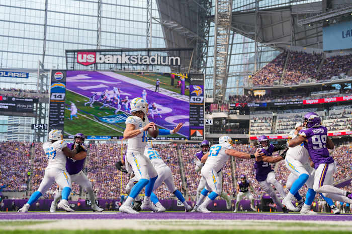 Justin herbert throws the ball looking downfield at US bank stadium